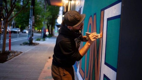 ezra dickinson painting a wall in seattle